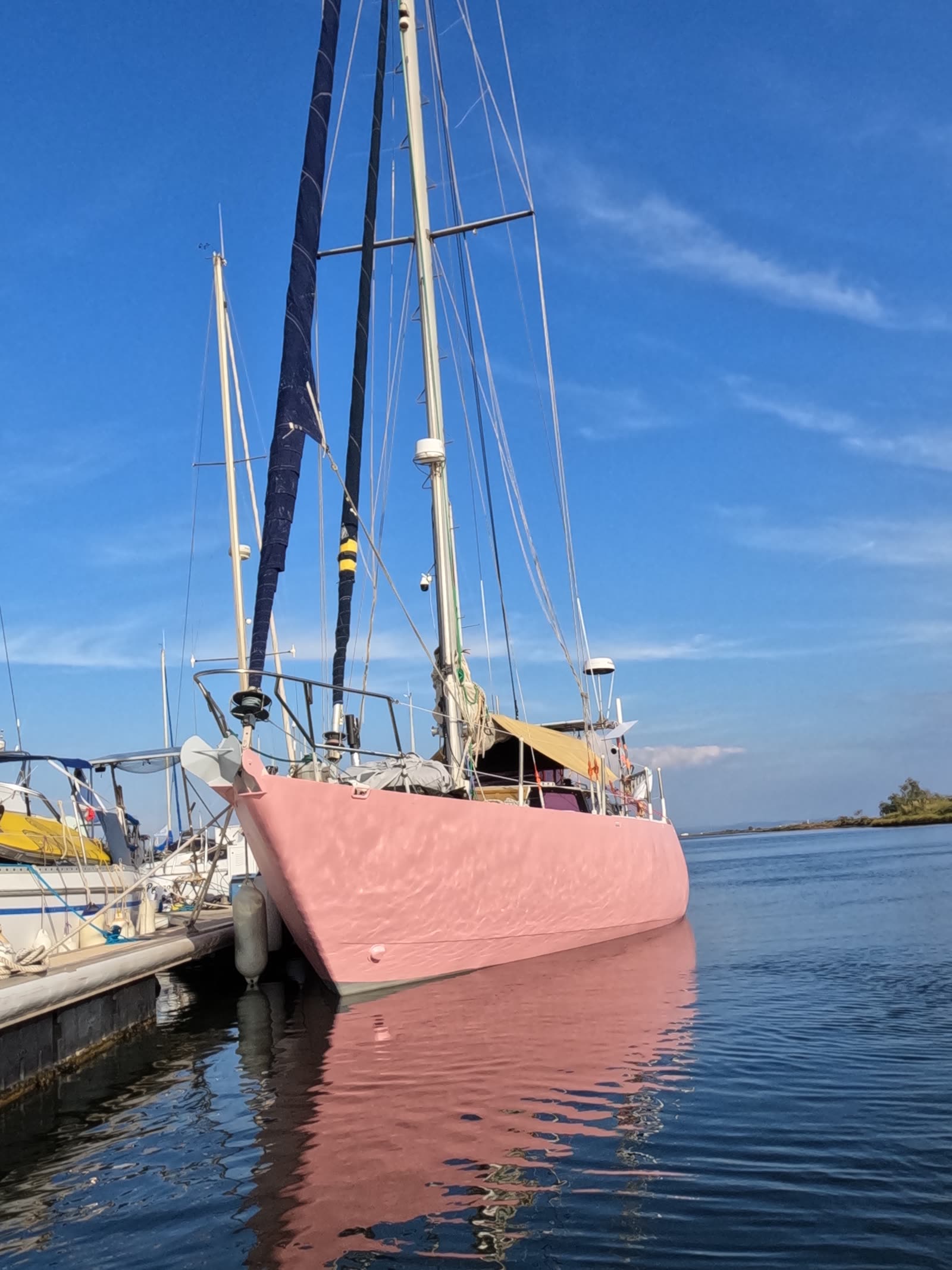 Malabar moored at Port Napoléon, masts against a blue sky